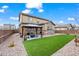 Spacious backyard with artificial turf, stone beds, and a gazebo covered patio at 224 S Jackson Gap Way, Aurora, CO 80018