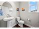 Stylish half bath with a vessel sink, modern fixtures, and a bright window with natural light at 224 S Jackson Gap Way, Aurora, CO 80018
