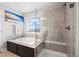 Bright bathroom features a soaking tub with tile surround and a glass-enclosed shower at 224 S Jackson Gap Way, Aurora, CO 80018