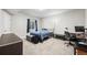 This bedroom features neutral walls, a black metal bed frame, and a dedicated desk space at 224 S Jackson Gap Way, Aurora, CO 80018