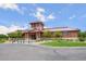 Exterior of the community clubhouse featuring professional landscaping and manicured lawns at 224 S Jackson Gap Way, Aurora, CO 80018