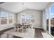 Bright dining room featuring a modern chandelier, large windows, and elegant table setting at 224 S Jackson Gap Way, Aurora, CO 80018