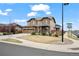 Inviting two-story home with a manicured front lawn and sidewalk access on a sunny day at 224 S Jackson Gap Way, Aurora, CO 80018