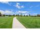 Scenic view of green space with sidewalks and well-maintained landscaping and trees at 224 S Jackson Gap Way, Aurora, CO 80018