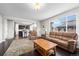 Open-concept living room featuring hardwood floors and a view of the adjacent kitchen area at 224 S Jackson Gap Way, Aurora, CO 80018