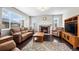 Inviting living room with a stone fireplace, hardwood floors, and comfortable leather furniture at 224 S Jackson Gap Way, Aurora, CO 80018