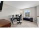 This loft features carpet floors, and a computer setup with a black gaming chair at 224 S Jackson Gap Way, Aurora, CO 80018
