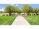 Beautiful park featuring a walkway with trees, benches, and landscaped gardens at 224 S Jackson Gap Way, Aurora, CO 80018