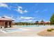 Community pool with lounge chairs, umbrellas, and a splash pad on a sunny day at 224 S Jackson Gap Way, Aurora, CO 80018