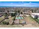 Aerial view of the property, showing the layout with tennis court, playground, gardens and accessory buildings at 6192 S Pennsylvania St, Centennial, CO 80121