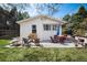 Inviting backyard with outdoor seating areas, a wooden bench, and mature trees at 6192 S Pennsylvania St, Centennial, CO 80121