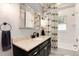 This bathroom includes a neutral countertop, a framed mirror, and a patterned shower curtain at 6192 S Pennsylvania St, Centennial, CO 80121
