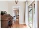 Bedroom view featuring hardwood floors, wooden desk, sliding glass doors, and neutral paint at 6192 S Pennsylvania St, Centennial, CO 80121