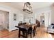 Formal dining room showcasing a dark wood table set, hardwood floors, and stylish light fixture at 6192 S Pennsylvania St, Centennial, CO 80121