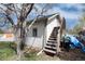 A side view of the building shows a staircase going to a second floor entrance at 6192 S Pennsylvania St, Centennial, CO 80121
