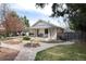 Attractive home with a welcoming front porch, swing, and meticulously maintained landscaping creating inviting curb appeal at 6192 S Pennsylvania St, Centennial, CO 80121