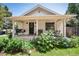 Charming covered front porch with a swing, seating, and beautifully landscaped yard at 6192 S Pennsylvania St, Centennial, CO 80121