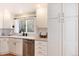 Bright kitchen featuring stainless steel appliances, granite countertops, and white cabinetry at 6192 S Pennsylvania St, Centennial, CO 80121