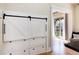 Cozy living room with sliding barn doors to the backyard and a built-in storage system at 6192 S Pennsylvania St, Centennial, CO 80121