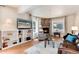 Cozy living room featuring hardwood floors, fireplace, and natural light at 6192 S Pennsylvania St, Centennial, CO 80121