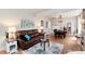 Spacious living room featuring hardwood floors, leather couch, and modern decor at 6192 S Pennsylvania St, Centennial, CO 80121