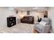 Cozy living room in finished basement with comfortable seating, carpet, and a decorative bookshelf at 6192 S Pennsylvania St, Centennial, CO 80121