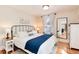 Bedroom with plush bed, wood floors, bright light, and a large mirror at 6192 S Pennsylvania St, Centennial, CO 80121