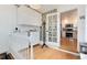 Mud Room with glass block, wood floors, coat rack and white cabinets at 6192 S Pennsylvania St, Centennial, CO 80121