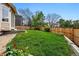 Beautiful backyard with lawn, garden bed, and privacy fence at 9515 Dolton Way, Highlands Ranch, CO 80126