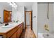 Bathroom featuring a double sink vanity, a shower/tub combo, and two open doorways at 9515 Dolton Way, Highlands Ranch, CO 80126