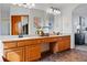 Bright bathroom with a double sink vanity and a view into the main bedroom at 9515 Dolton Way, Highlands Ranch, CO 80126