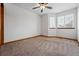 Bright bedroom featuring a ceiling fan and multiple large windows at 9515 Dolton Way, Highlands Ranch, CO 80126