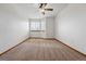 Bright bedroom featuring a ceiling fan and multiple large windows at 9515 Dolton Way, Highlands Ranch, CO 80126