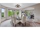 Bright dining room with glass table, seating for six, and seamless flow to the living room at 9515 Dolton Way, Highlands Ranch, CO 80126
