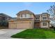 Attractive two-story home featuring a three-car garage, well-kept lawn, and appealing architectural design at 9515 Dolton Way, Highlands Ranch, CO 80126