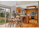 Charming kitchen with light wood cabinets, stainless steel appliances, and a breakfast nook with backyard access at 9515 Dolton Way, Highlands Ranch, CO 80126