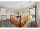 Upstairs landing with wood railing and access to bedrooms; natural light fixture and artwork at 9515 Dolton Way, Highlands Ranch, CO 80126