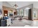 Inviting living room with a brick fireplace, built-in shelves, and large windows with views to the backyard at 9515 Dolton Way, Highlands Ranch, CO 80126