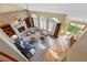 Open-concept living room with fireplace, built-in shelving, vaulted ceilings, and large windows at 9515 Dolton Way, Highlands Ranch, CO 80126