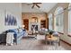 Inviting living room featuring a brick fireplace, built-in shelving, and large windows for ample natural light at 9515 Dolton Way, Highlands Ranch, CO 80126