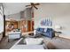 Bright living room with vaulted ceiling, a ceiling fan, and open floor plan for entertaining at 9515 Dolton Way, Highlands Ranch, CO 80126