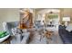 Cozy living room featuring stylish seating, neutral tones, and an open layout connecting to the dining area at 9515 Dolton Way, Highlands Ranch, CO 80126