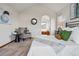 Serene main bedroom featuring accent chair, arched doorway to ensuite bath, and neutral decor at 9515 Dolton Way, Highlands Ranch, CO 80126