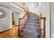 Beautiful curved staircase with wooden handrail and carpeted steps leading to the upper level at 9515 Dolton Way, Highlands Ranch, CO 80126