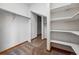 Bright walk-in closet with built-in shelves and multiple metal hanging rods at 9515 Dolton Way, Highlands Ranch, CO 80126