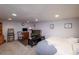 Finished basement with a bed, TV, and workspace at 5221 W Rowland Pl, Littleton, CO 80128