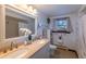 Elegant bathroom with double vanity and a large mirror at 5221 W Rowland Pl, Littleton, CO 80128