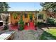 Backyard features a covered patio with lights, climbing plants, and a manicured lawn at 1332 Ash St, Denver, CO 80220