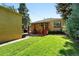Backyard features a well-maintained lawn, a cozy patio with outdoor seating, and a hammock at 1332 Ash St, Denver, CO 80220
