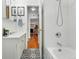 Bathroom featuring stylish tile flooring, a shower/tub combo, and bright natural light at 1332 Ash St, Denver, CO 80220